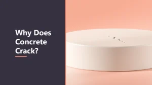 Featured image with the headline Why Does Concrete Crack, beside a smooth pale round concrete slab with a small crack on its top